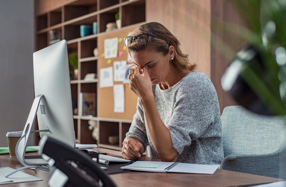 Business woman having headache at office