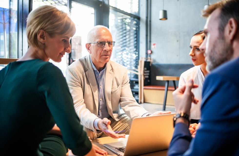 Serious disscussion about project during business meeting in cafe